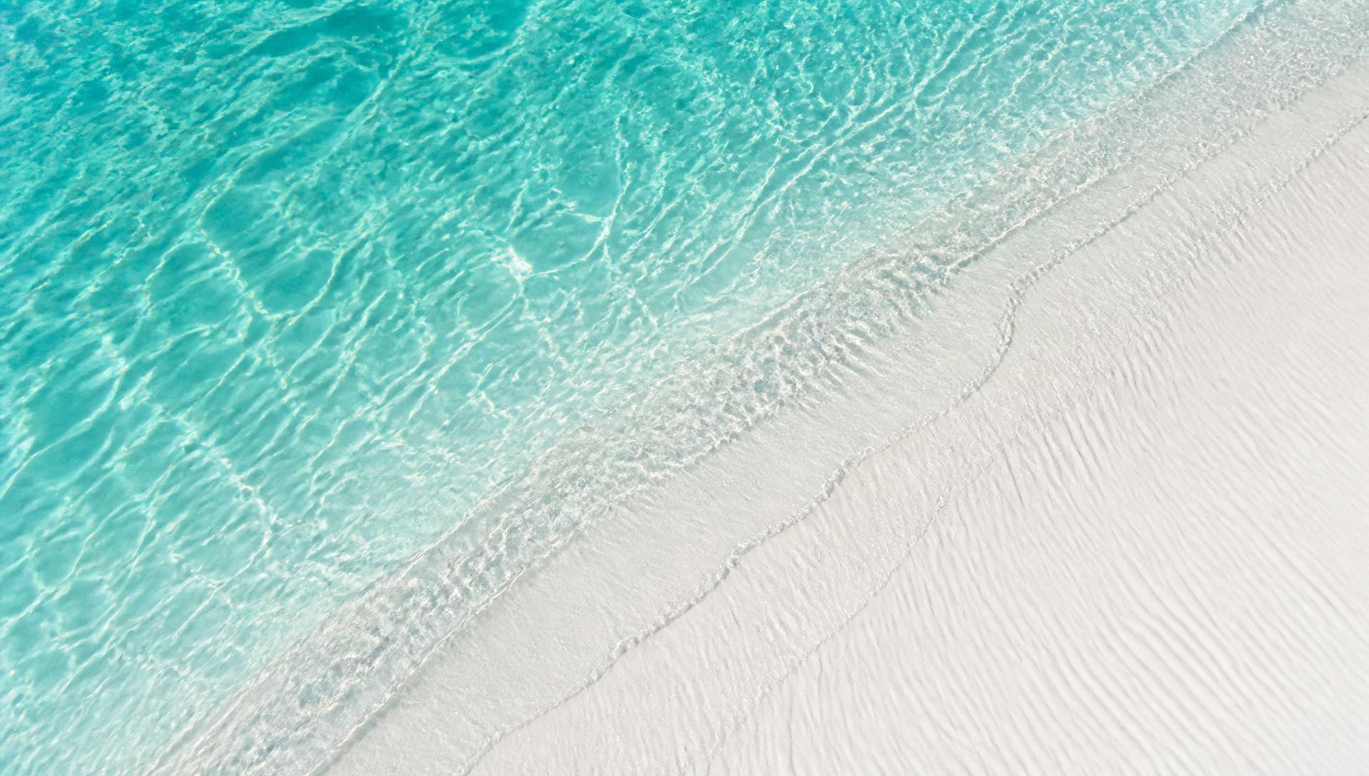 Sugar-white 30A sand meeting turquoise Emerald Coast water
